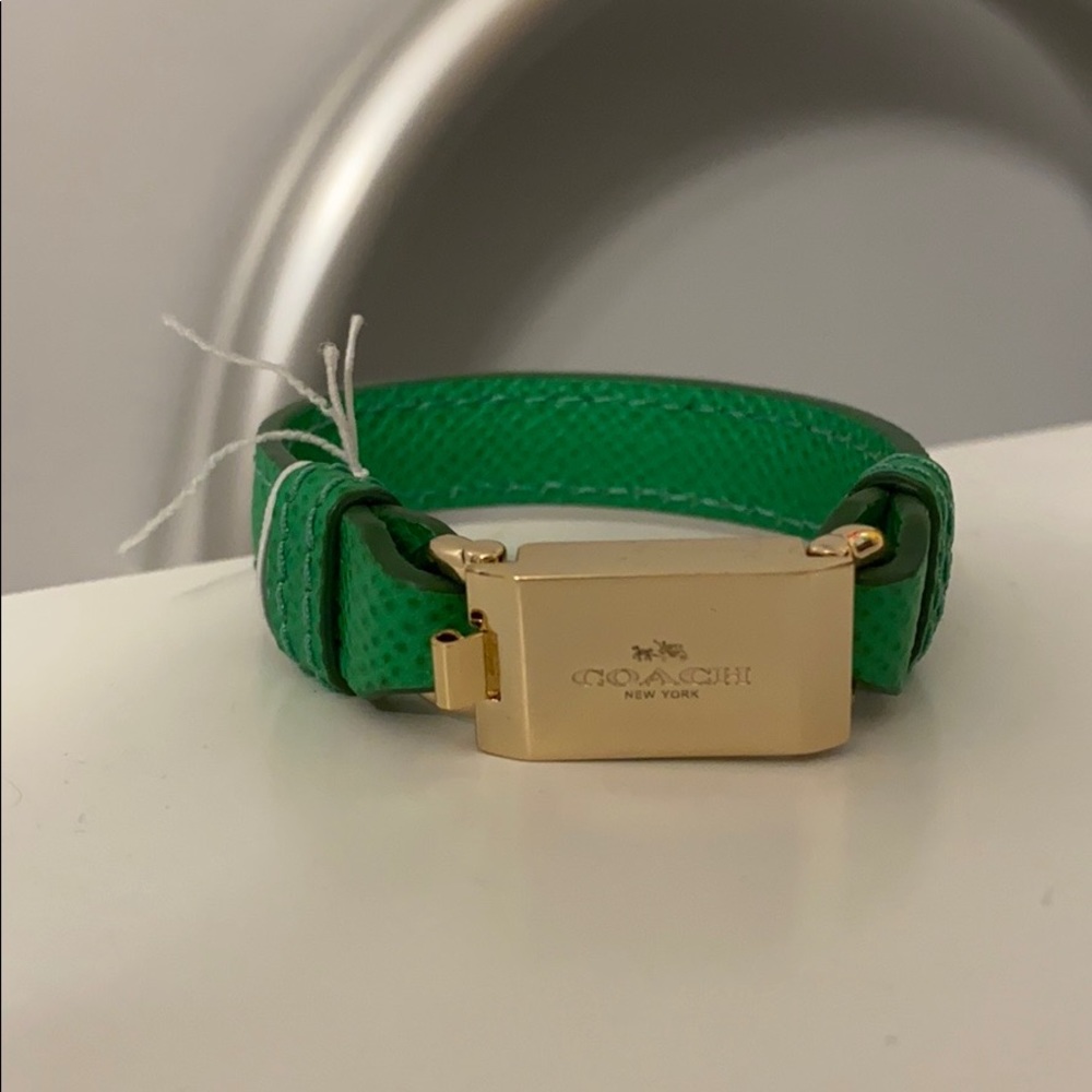 Coach bracelet with gold clasp and green band